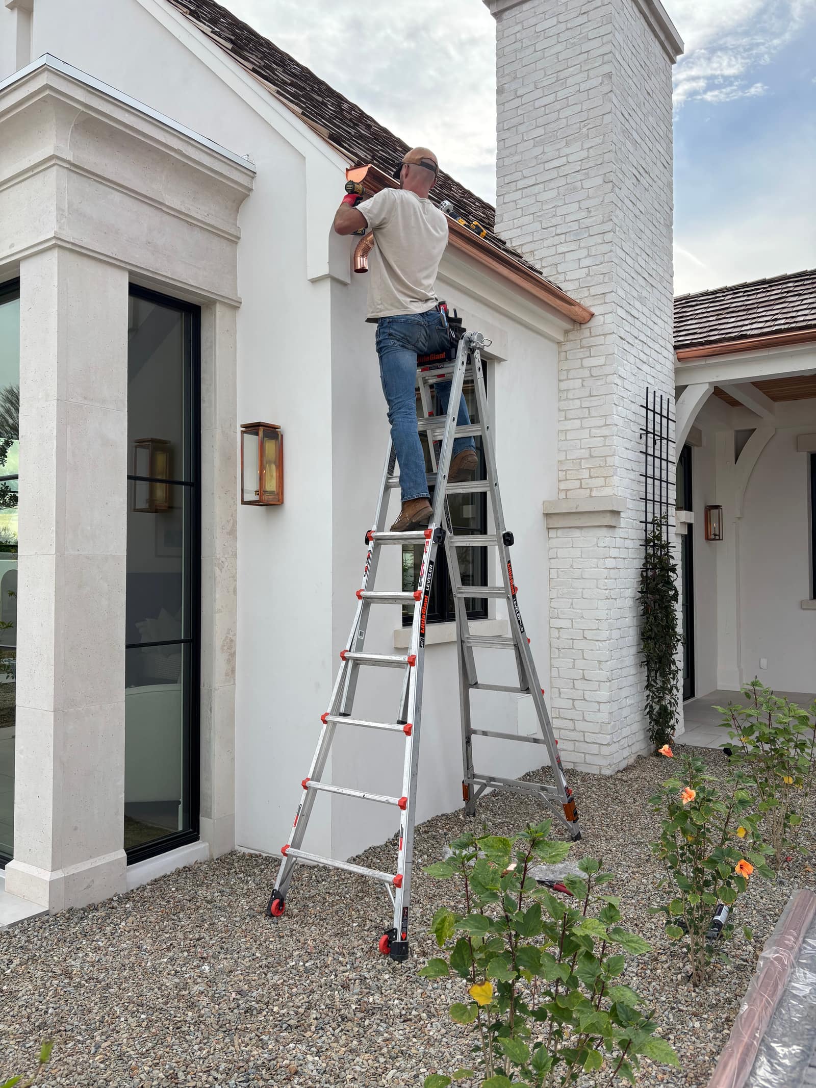 Grizzly Rain Gutters crew installing seamless gutters on a Phoenix-area home