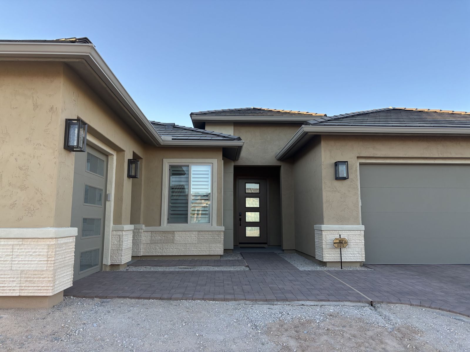 Seamless aluminum gutters on modern Phoenix desert home front entry — Grizzly Rain Gutters