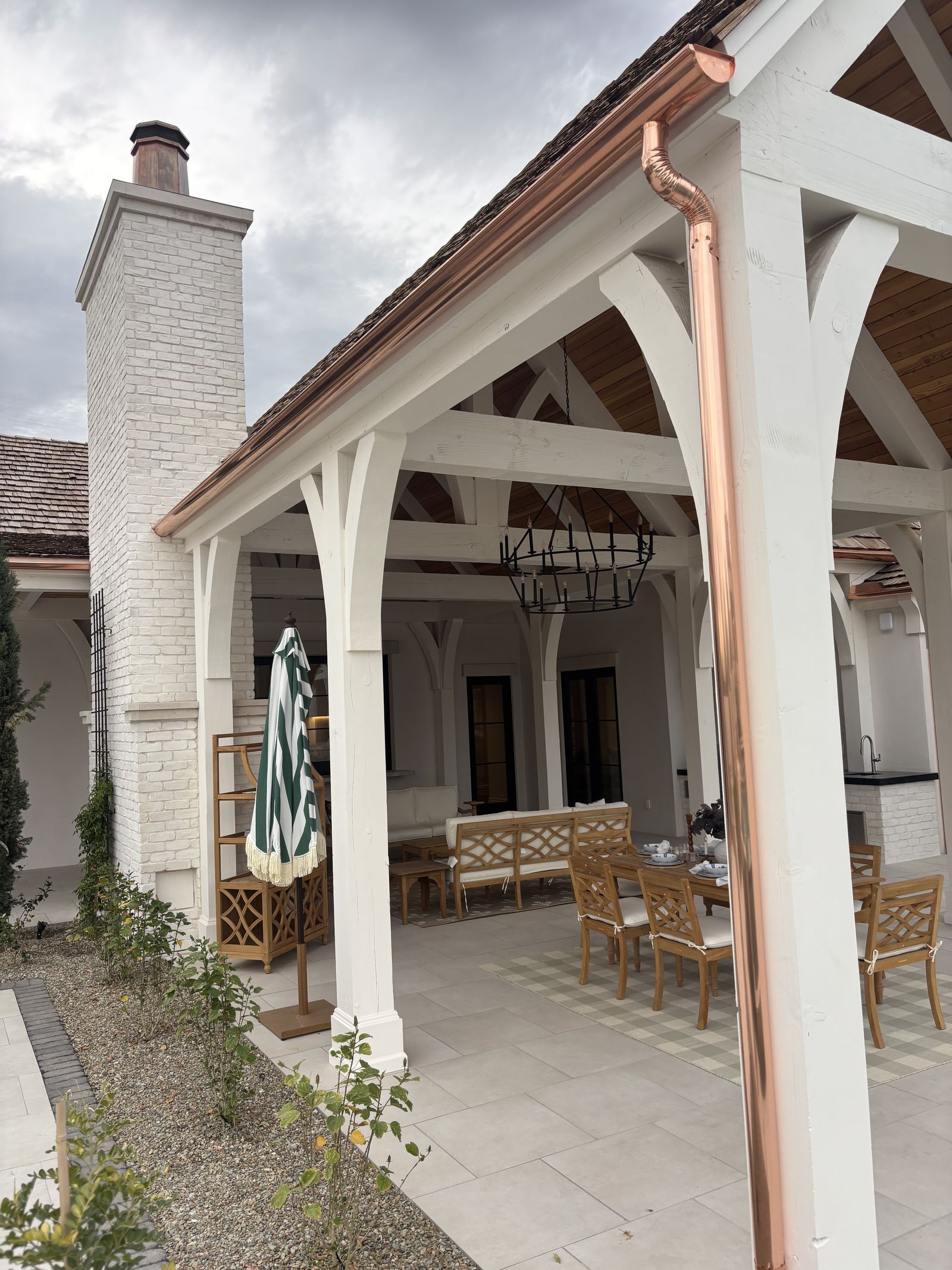 Copper downspout on covered patio column with loggia — Grizzly Rain Gutters