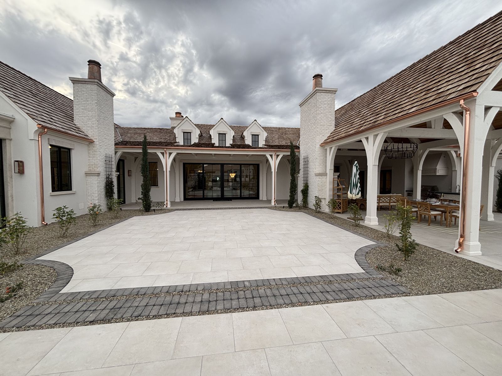 Wide courtyard view with copper gutters on outdoor living area — Grizzly Rain Gutters