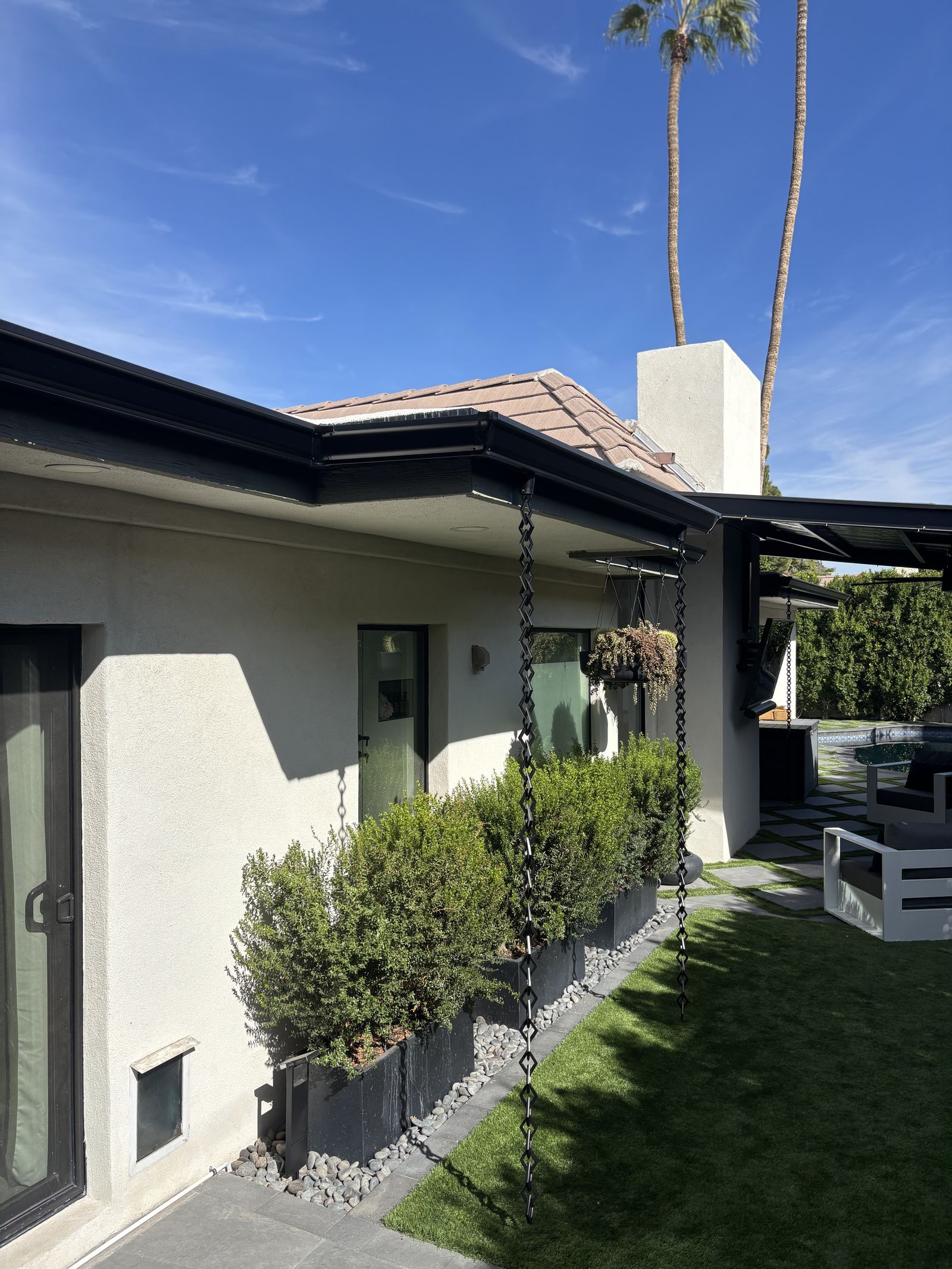 Rain chains on black seamless gutter mitered corner — Grizzly Rain Gutters