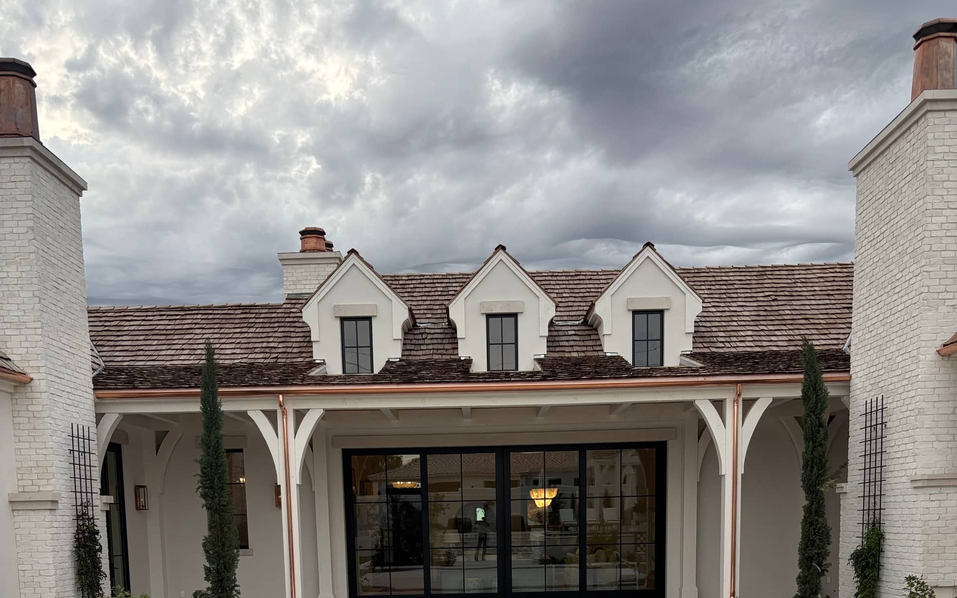 Copper seamless rain gutters on a French-estate courtyard in the Phoenix Valley installed by Grizzly Rain Gutters